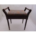 A mahogany rectangular piano stool with hinged upholstered seat on four turned legs