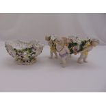 A Sitzendorf porcelain oval bocage pierced fruit basket mounted on four putti figurines and