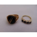 A 9ct yellow gold and onyx signet ring and a 9ct yellow gold, sapphire and diamond ring, approx