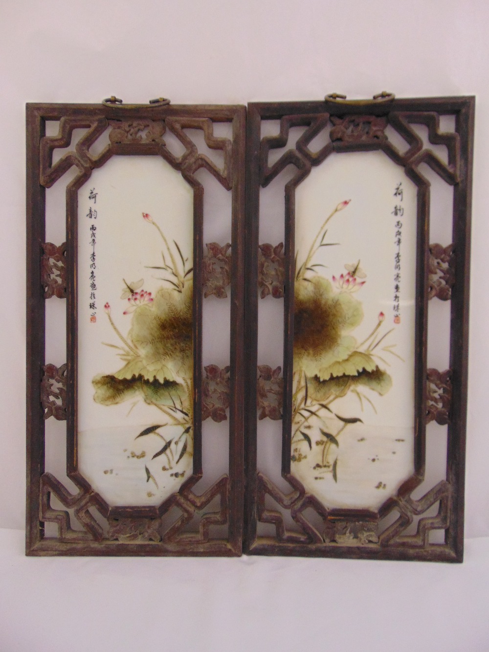 A pair of Chinese Republic Period famile verte porcelain panels in hardwood rectangular pierced