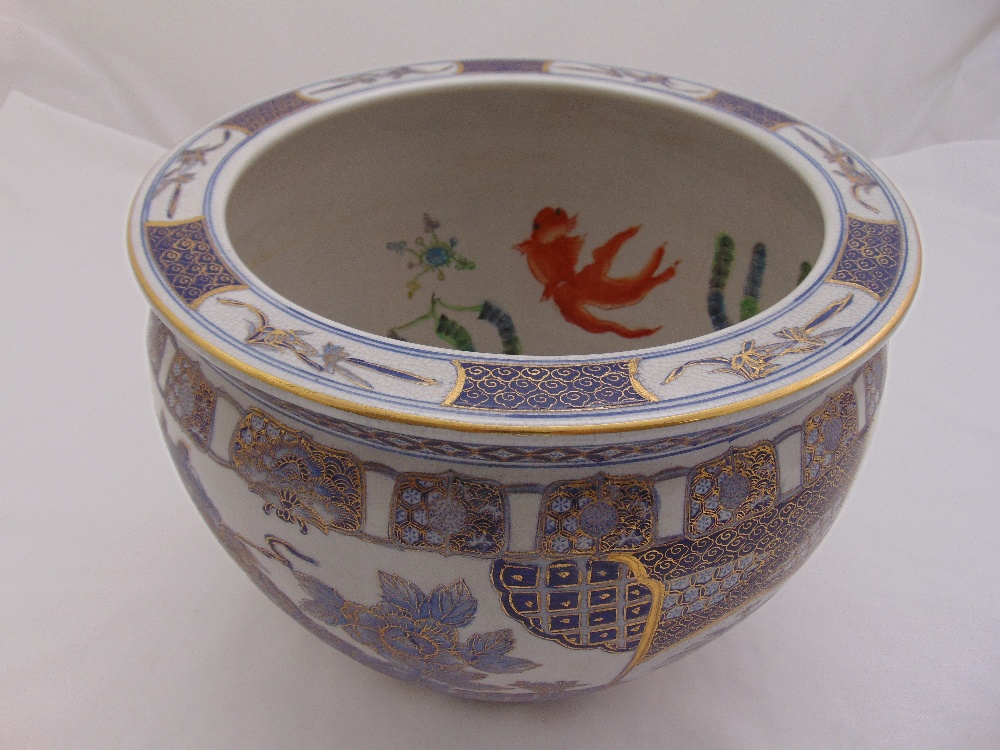 A Chinese fish bowl of customary form decorated with flowers and scrolls, 28.5cm (h) 36cm diameter