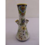 A Faience stem vase of waisted cylindrical form, decorated with flowers and leaves, 23cm (h)