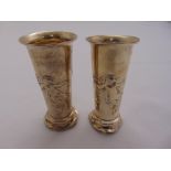 A pair of Art Nouveau silver vases tapering cylindrical chased with female figures on circular bases