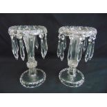 A pair of glass lustres of vase form on raised circular bases, 23cm (h)