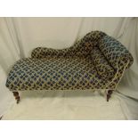 A Victorian chaise longue of customary form on turned mahogany legs