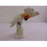 A Meissen figurine of a parrot on a branch, marks to the base, 23.5cm (h)