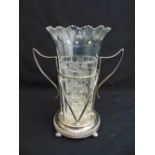 A silver plated two handled stand with a cut glass vase all on four bun feet, 25cm (h)