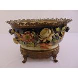 A Majolica jardinire by Edward Gillies of circular form with applied flowers and pierced brass