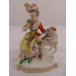 Meissen figurine of a lady holding flowers seated next to a table, on shaped rectangular plinth,
