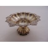 A silver bonbon dish with pierced and floral rim on raised base, Sheffield 1921 by Cooper Brothers