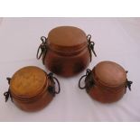 Three graduated hand hammered copper pots with pull off covers and side handles, largest 20cm (h)