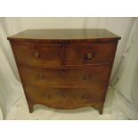An early 19th century mahogany bow fronted chest of drawers with brass handles on four bracket feet