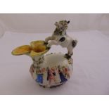 A Majolica milk jug the sides decorated with figures and masks, the handle in the form of a stylised