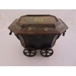 A late 19th century Toleware octagonal coal scuttle with pierced scroll side handles on four pierced