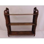 A rectangular mahogany wall mounted shelf