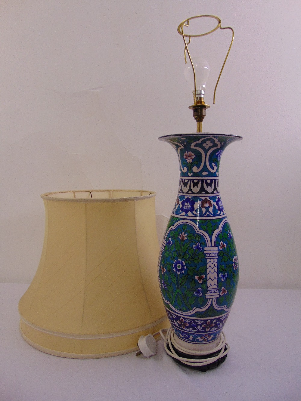 A Chinese baluster vase decorated with flowers and scrolls table lamp on a carved hardwood stand