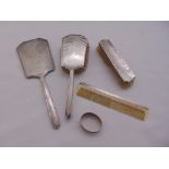 A quantity of hallmarked silver to include a four piece dressing table set and a napkin ring