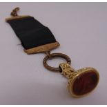 A gold seal with carved carnelian intaglio, tested 14ct