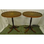 A pair of Edwardian oval side tables inset with satinwood stringing and decoration on four