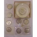 Eight uncirculated Liberty dollar coins and an 1883 dollar coin paperweight