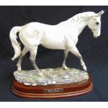 A Royal Doulton limited edition porcelain figurine of Desert Orchid 2730/7500 on wooden stand,