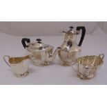 A four piece silver teaset, shaped oval with angled handles on oval bases to include sugar tongs,