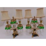 A pair of two light glass and gilded metal candelabra table lamps with crystal drops and silk
