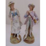 A pair of French bisque figurines dressed in 18th century costume, signed to the base, 50cm (h)