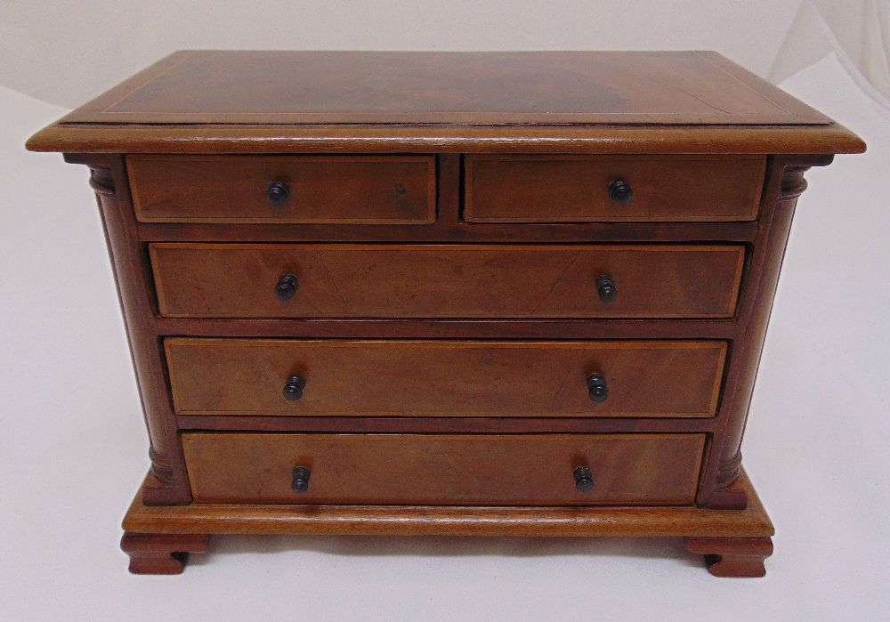 An Edwardian rectangular mahogany miniature chest of drawers on four bracket feet, possibly an