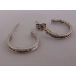 A pair of white gold and diamond channel set earrings, tested 18ct, approx total weight 2.3g