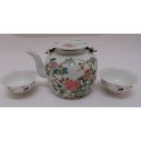 A Chinese Republic period teapot decorated with flowers and leaves and two tea bowls, 12cm (h)