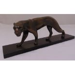 A cast bronze figurine of a Jaguar mounted on a rectangular black marble plinth, 17cm (h) 48cm (w)