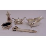 A quantity of silver to include a condiment set, a sauce boat and a cigar cutter (5)