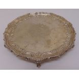 A Victorian silver salver, circular with beaded border, monogram engraved to the centre on three