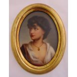 A framed oval oil on porcelain portrait of a young lady wearing a gold necklace, 17 x 12cm