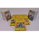 A pair of Wedgwood Rupert the Bear porcelain bookends and five Rupert The Bear volumes