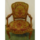 A mahogany armchair with upholstered tapestry seat and back on cabriole legs