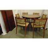 Danish rosewood circular dining table with drop in leaves and six matching upholstered dining chairs