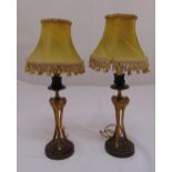 A pair of gilded metal table lamp stands on raised circular bases with shades, 38cm (h)