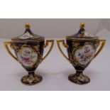 A pair of Vienna vases and covers with gilded angled handles and floral sprays to the sides, the