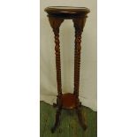 A mahogany plant stand with barley twist supports and four outswept feet, 101cm (h)
