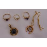 Three 9ct gold rings, a 9ct gold pendant and a 9ct gold charm in the form of a horseshoe with a