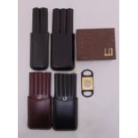 Four Dunhill leather cigar cases and one cigar cutter
