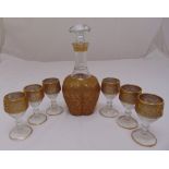 A Bohemian gilded glass decanter with drop stopper and six matching liqueur glasses