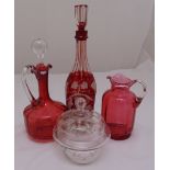 Two Victorian cranberry glass ewers, a red overlaid Bohemian decanter and a small hand-painted