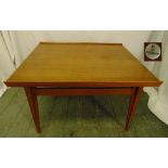 A rectangular 1970s teak coffee table, on four tapering rectangular legs, makers label to