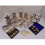 A quantity of silver plate to include teasets, wine bottle coasters and cased egg cup holders