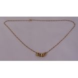 9ct yellow gold chain with seven gold rings, approx total weight 3.6g