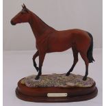 A Royal Doulton limited edition porcelain figurine of Red Rum 93/7500 on wooden stand, 37cm (h) 35cm