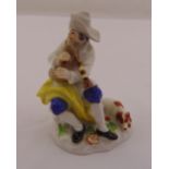 Meissen figurine of shepherd playing bagpipes with his dog on naturalistic base, marks to the base